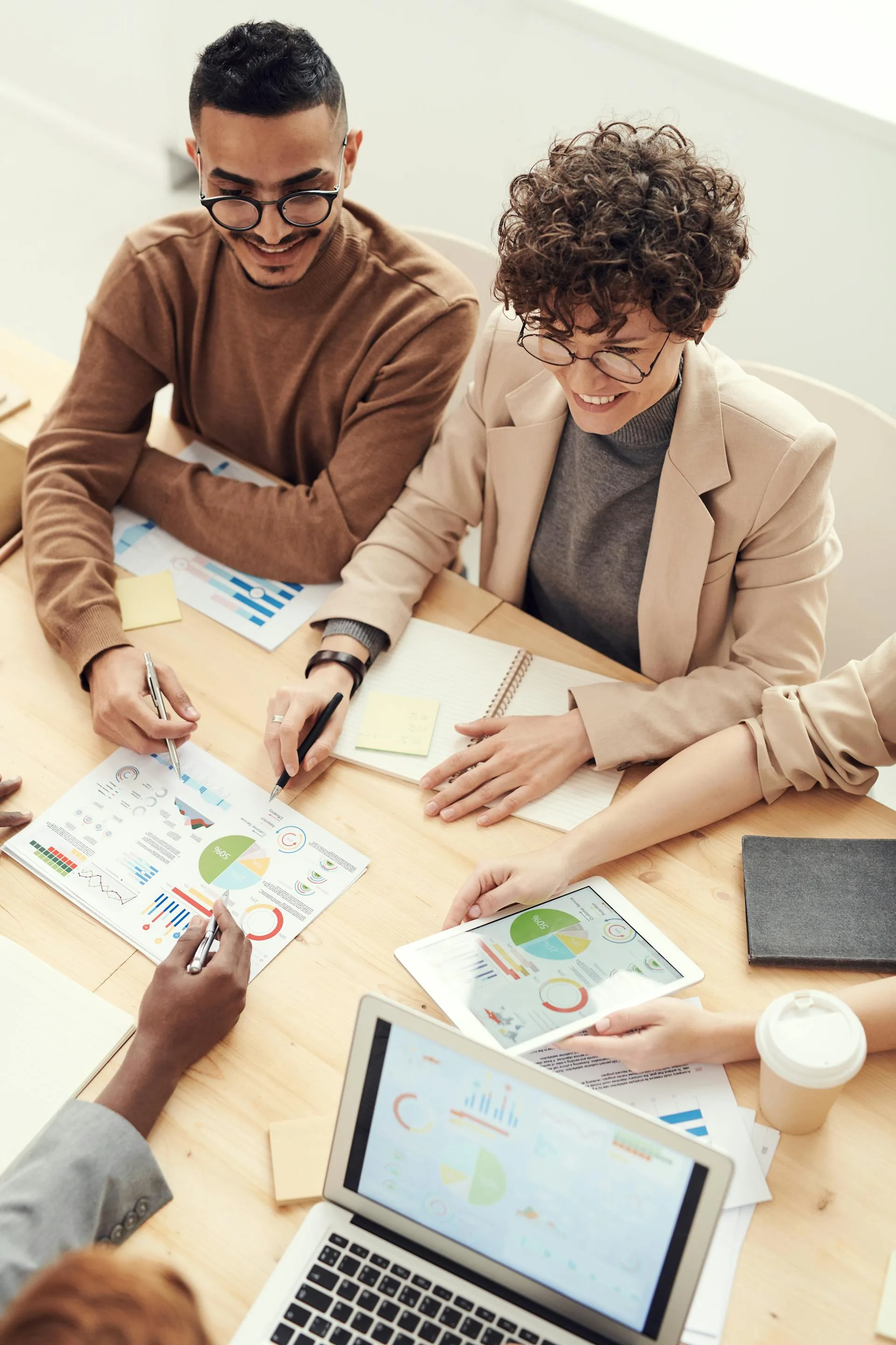 Professionals collaborating over documents at a table